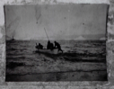 Image of Four men setting out in open boat. Icebergs and vessel  beyond  (V-14)