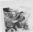 Image of Norman Turcotte cutting Bill Bulter's hair