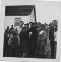 Image of Joe Rich and some of the Innu [l-r: Dominik Pokue, Kaniuekutat (John) Poker (center), Pinip Rich, Joe Rich, Shinateapissinem (Charles) Pokue, Nuke Pokue (background, right)]