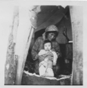 Image of Innu mother and baby in tent doorway [Penash Pokue and child]