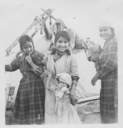 Image of Innu mother and children by tent [Akat (Agathe), Manishan (Mary Jane) Pasteen, Shanut (Janet) Pateen, Tshimish (James) Pasteen, Miniskuess Pasteen (woman)]
