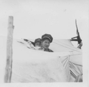 Image of Two Indian [Innu] boys wearing sailing caps look out of tent