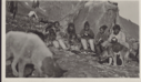 Image of Inuit families by tupik, dogs near. Tent and supplies beyond