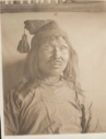 Image of Accomoding-wah [inuit man wearing knit cap with large tassel. Portrait]