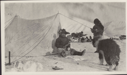 Image of Inuit men by tent. Dogs, sledge; men hold long knives