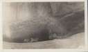 Image of Inuit with team at base of cliff