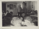 Image of Two men,  and children in schoolroom