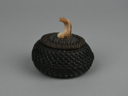 Image of baleen basket with fossil ivory finial carved into whale flukes