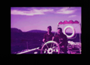 Image of Two crewmen at wheel of BOWDOIN  [purple]