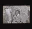 Image of Inuit woman sitting by tupik  [b&w]