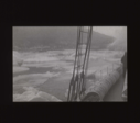 Image of Ice pans through rigging and over rail [b&w]