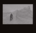 Image of Crewman climbs snowy peak  [b&w]