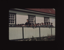 Image of Donald MacMillan and school boys by fence