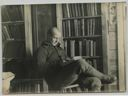 Image of Donald MacMillan reading in library of Borup Lodge