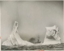 Image of Coast Guard cutter seen between two sections of an iceberg