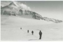 Image of Men trekking on snow near mountain peak