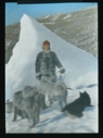Image of Ekblaw by tip of grounded iceberg, with dogs