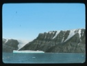 Image of Large ice floe by coastal hills