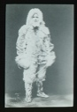 Image of Portrait: Donald MacMillan in furs, standing with dog whip (interior)