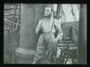 Image of Man standing on deck of a large vessel