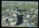 Image of Woman working on stone igloo