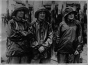 Image of Three women crew mnembers on the SACHEM. Mrs. Rowe Metcalf, Marion Smith. Miss Maude Fisher, in rain gear