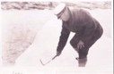 Image of Man bending over, using pick axe