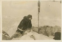 Image of Man looking at windsock on pole. Soviet Polar Expedition
