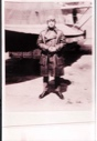 Image of Man in aviator's long coat, standing by plane