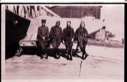 Image of Four aviators stand beside a plane