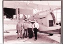Image of Four men standing near plane
