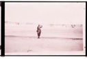 Image of Woman waving. Three (?) planes beyond
