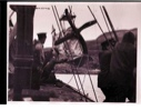 Image of Men on the S.S. PEARY, near a plane's propeller