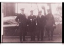 Image of Eugene McDonald, Donald MacMillan unidentified man and Richard Byrd stand on the S.S. PEARY