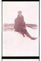 Image of Man, sitting on snow or ice with ice ax 