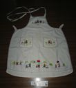 Image of Embroidered apron with Inuit figures and schoolhouse