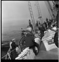 Image of "Shipwreck photos" -  small boat near BOWDOIN. Pilot Peter Peterson sits on titled deck