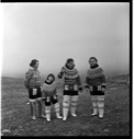 Image of Three Inuit women and a girl in traditional dress, front view