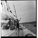 Image of ? on deck, Miriam standing at wheel - waving