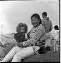 Image of Polar Eskimo [Inughuit] mother and child sitting on sledge