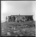 Image of Group of Polar Eskimos [Inughuit] by house