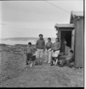 Image of Eskimo [Inuit] family by its [their] home