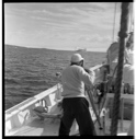 Image of Jack photographing iceberg from deck