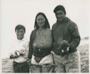 Image of Inuit couple and boy,with pups. Her arm in a sling [Angussuanguaq Duneq, Sofie and Utuuniaq Alatak]