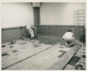 Image of Two men laying new floor, Thule AFB