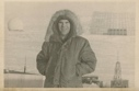 Image of Harold Grundy in parka near radome (postcard)