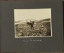 Image of Zum Inlandeis [To the Inland Ice, man walking up shore area, well bent over from large load he is carrying on his back]