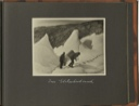 Image of Im Gletscherbruch [In the glacier breach?: [Two men follow foot-prints up the glacier. One carries large box on his back]