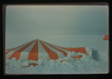 Image of Orange and white tent in snow.