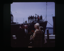 Image of People standing on dock and ship.
